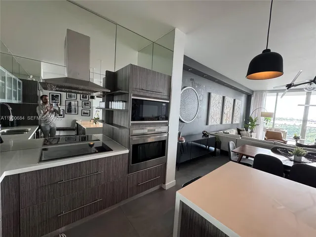 a bathroom with a sink vanity mirror and toilet