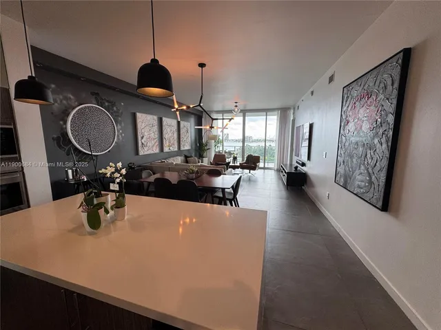 a spacious bedroom with furniture and a baby crib