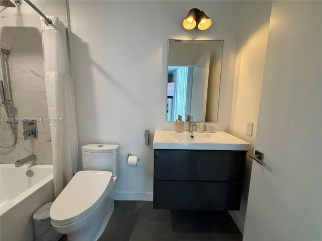 a living room with furniture and floor to ceiling window