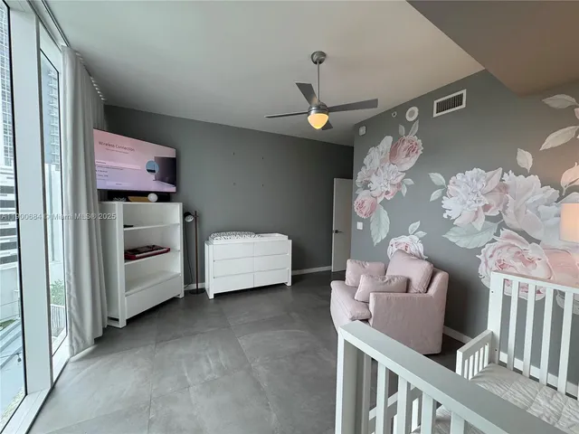 a living room with furniture and floor to ceiling window