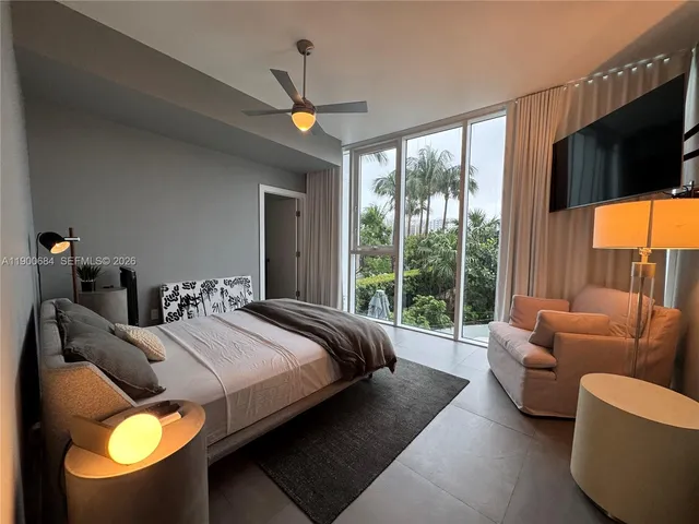 a living room with furniture and large windows