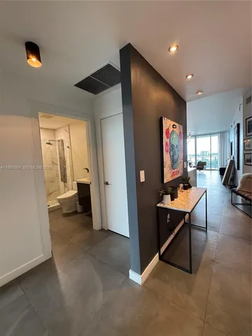a living room with furniture and a floor to ceiling window