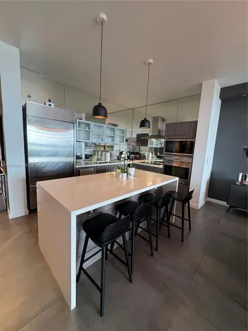 a view of empty room with wooden floor and cabinet