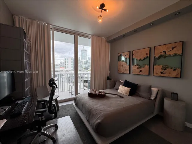 a view of empty room with wooden floor and cabinet