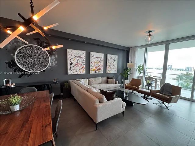 a bedroom with a bed a couch and large window