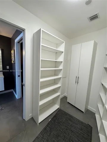 a view of a deck with table and chairs potted plants and wooden floor