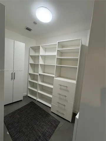 a view of a dining room with furniture and a potted plant