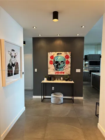 a view of hallway with livingroom and furniture