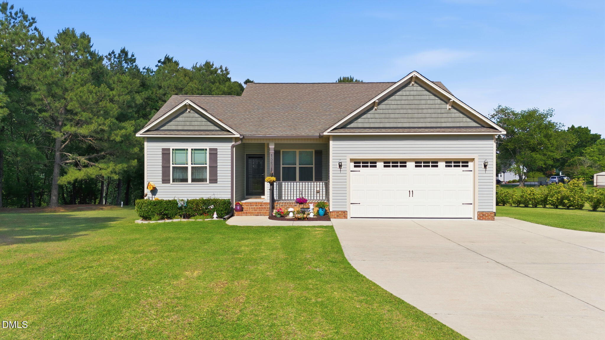 1547 Lassiter Pond Road Four Oaks, NC 27524 - Photo 1 of 45 a front view of a house with a yard and trees