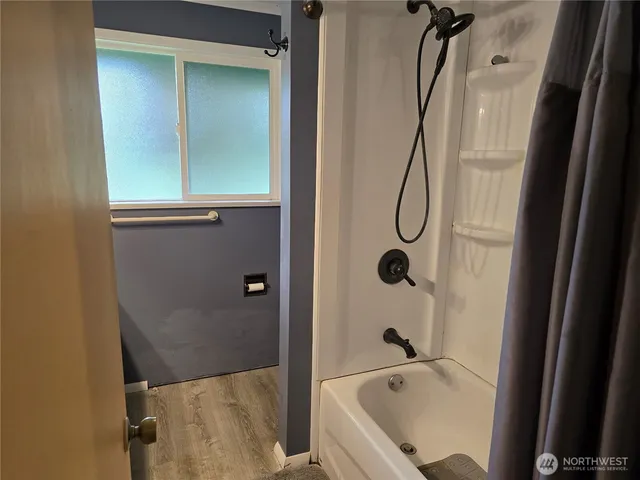a bathroom with a bath tub and shower