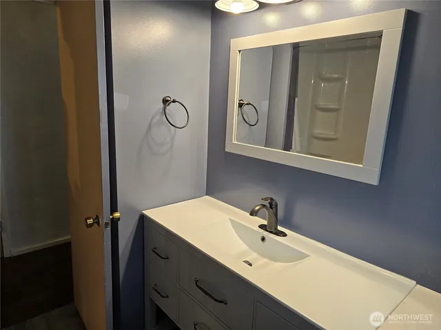 a bathroom with a sink and mirror