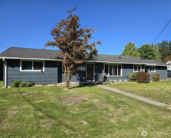 a backyard of a house with table and chairs