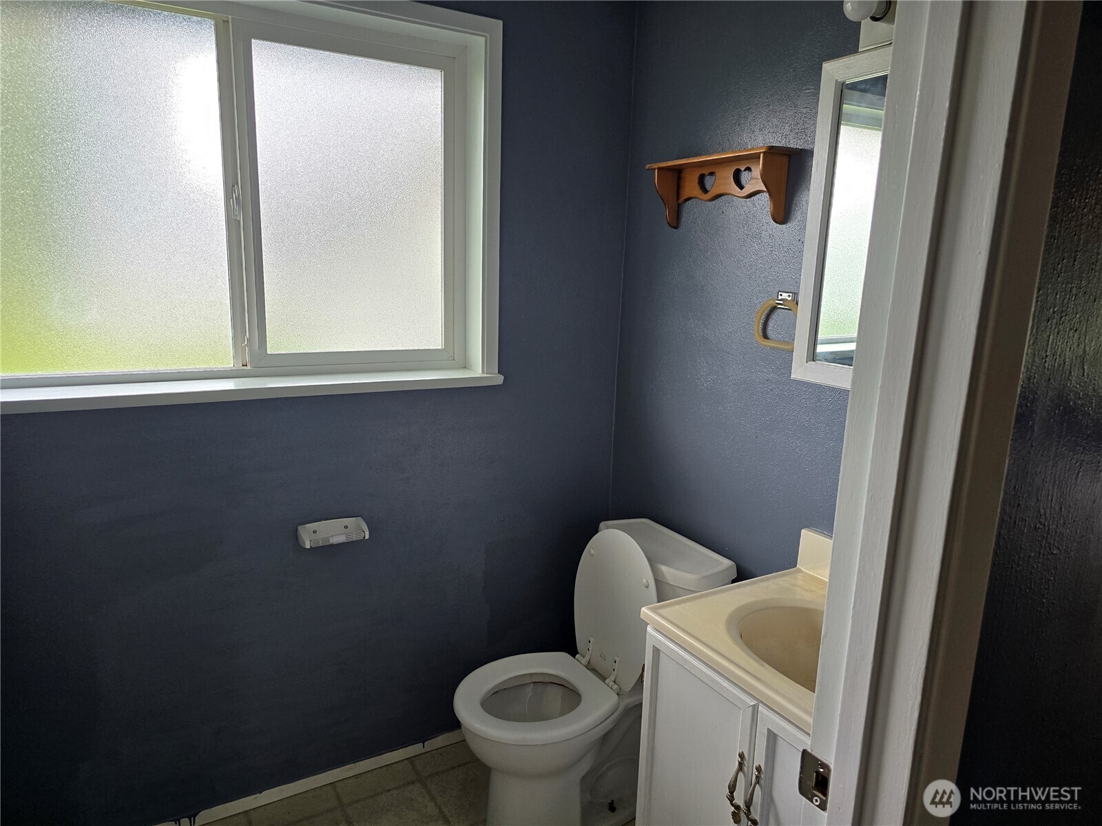 711 F Street Forks, WA 98331 - Photo 7 of 26 a white toilet sitting next to a window