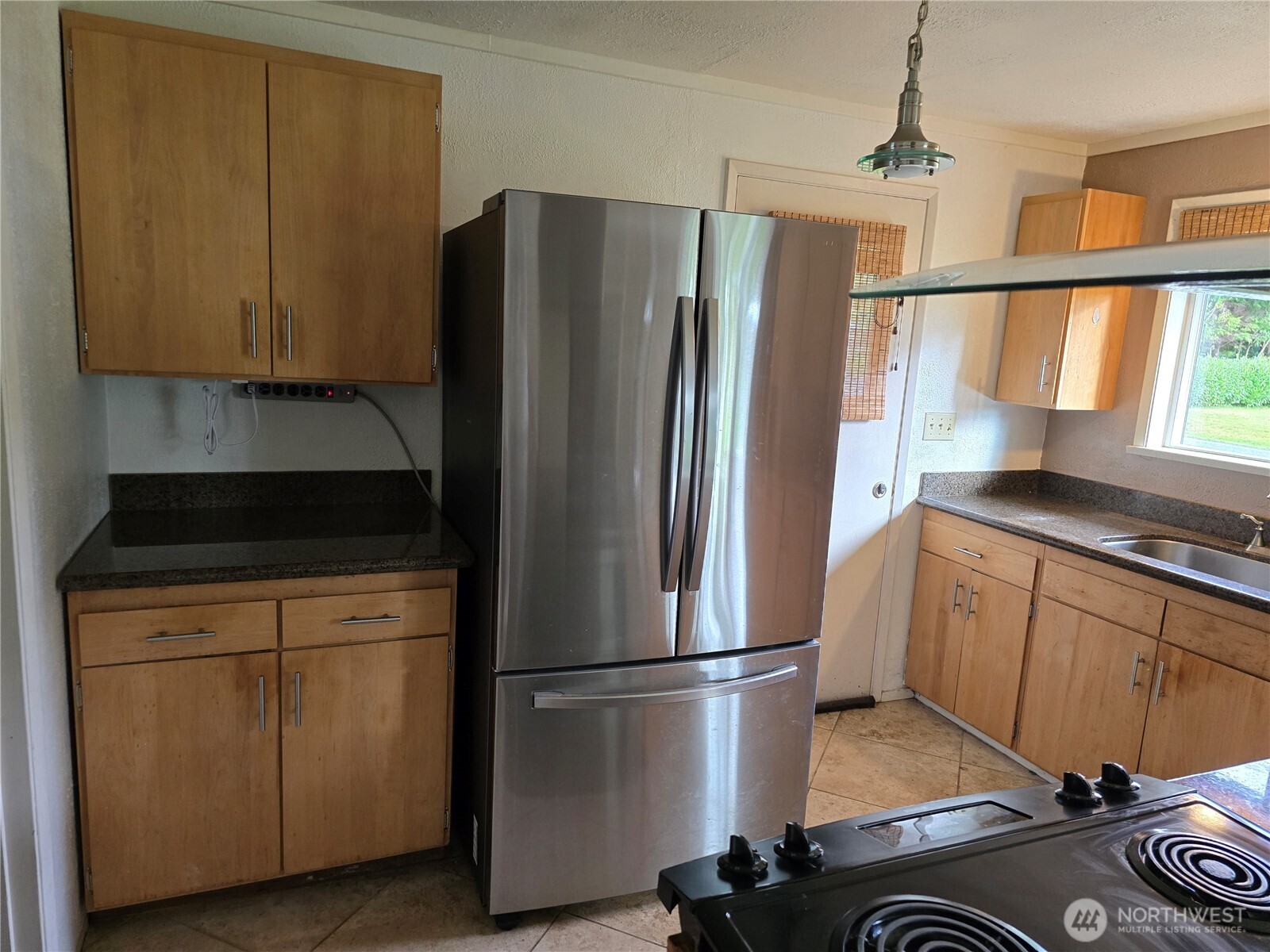 711 F Street Forks, WA 98331 - Photo 8 of 26 a kitchen with a refrigerator a stove a sink and a window