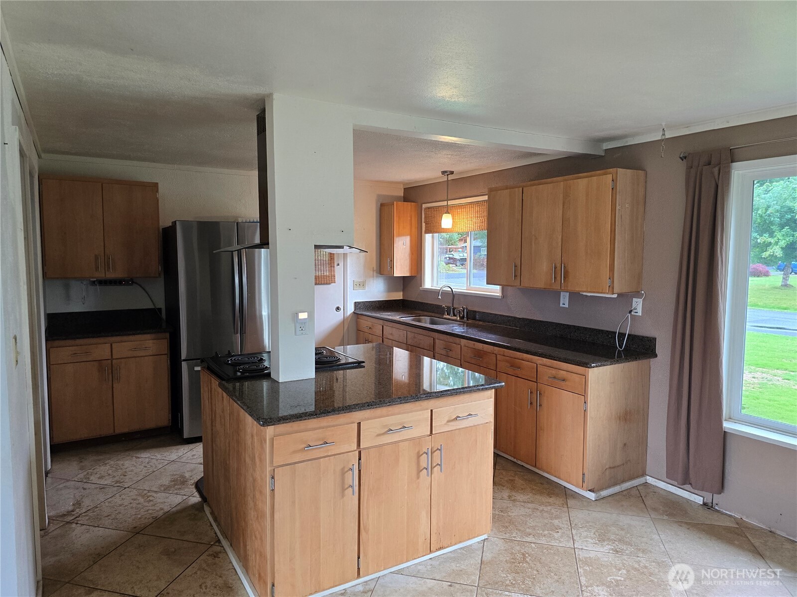 711 F Street Forks, WA 98331 - Photo 9 of 26 a kitchen with stainless steel appliances granite countertop a refrigerator and a sink
