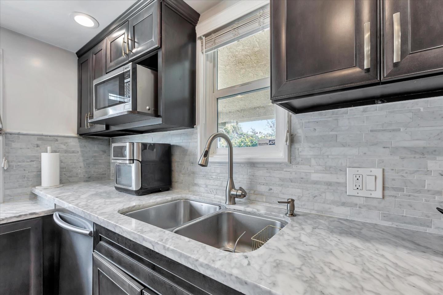 39 Carnegie Drive Milpitas, CA 95035 - Photo 11 of 39 a kitchen with stainless steel appliances granite countertop a sink and a microwave