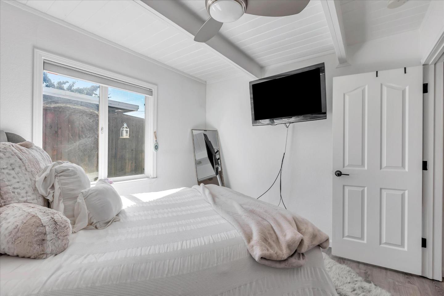 39 Carnegie Drive Milpitas, CA 95035 - Photo 19 of 39 a bedroom with a bed tv and a window