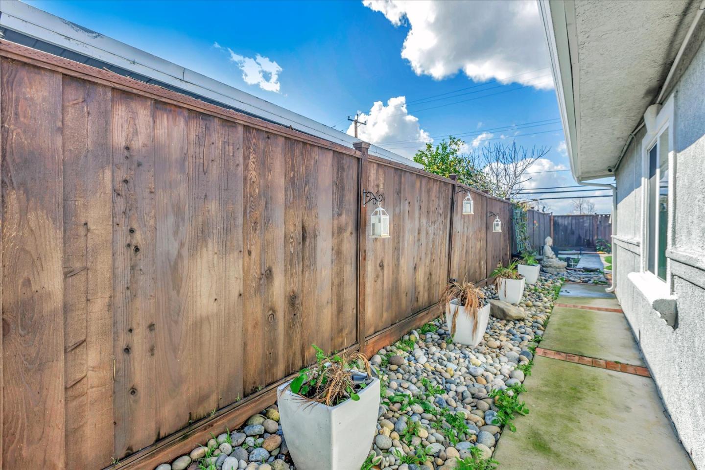 39 Carnegie Drive Milpitas, CA 95035 - Photo 37 of 39 a backyard of a house with table and chairs with wooden fence