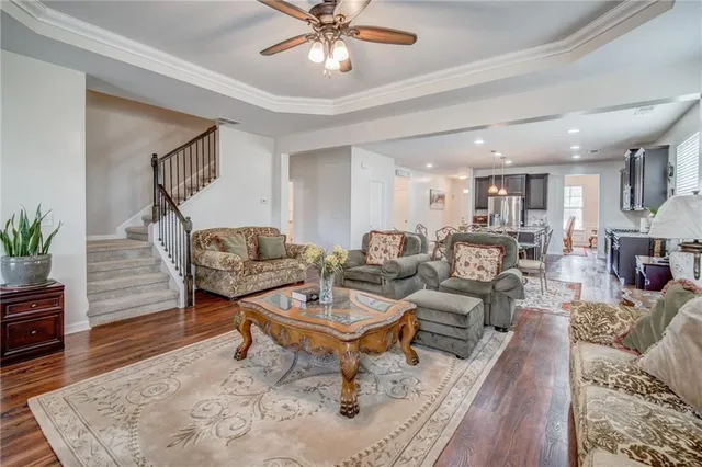 a living room with furniture and a wooden floor
