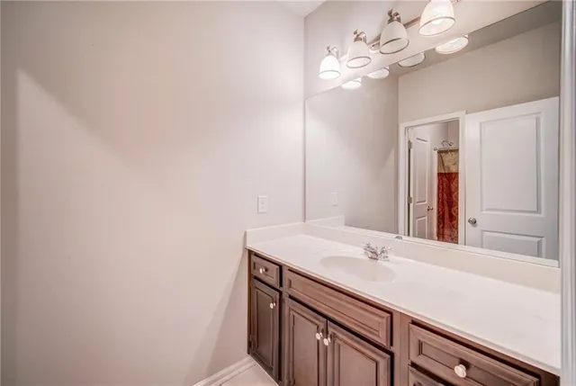 a bathroom with a sink vanity and a mirror