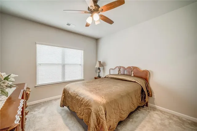 a bed sitting in a bedroom next to a window