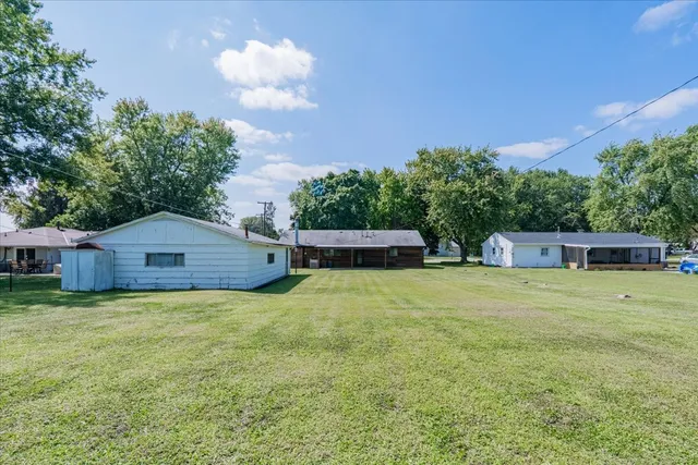 a swimming pool with outdoor seating and yard