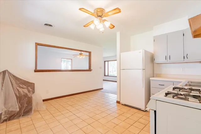 a kitchen with white cabinets and white appliances