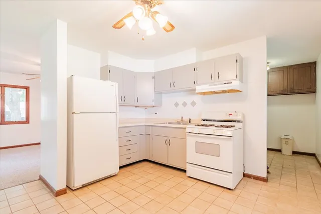 a kitchen with a stove cabinets and window
