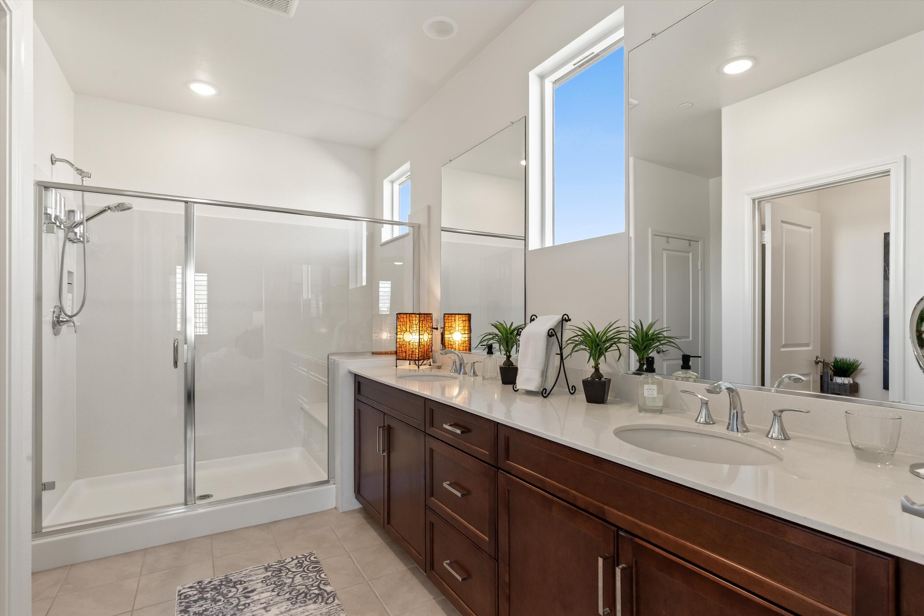 42940 Ascona Lane Indio, CA 92203 - Photo 13 of 36 a bathroom with a double vanity sink mirror and shower