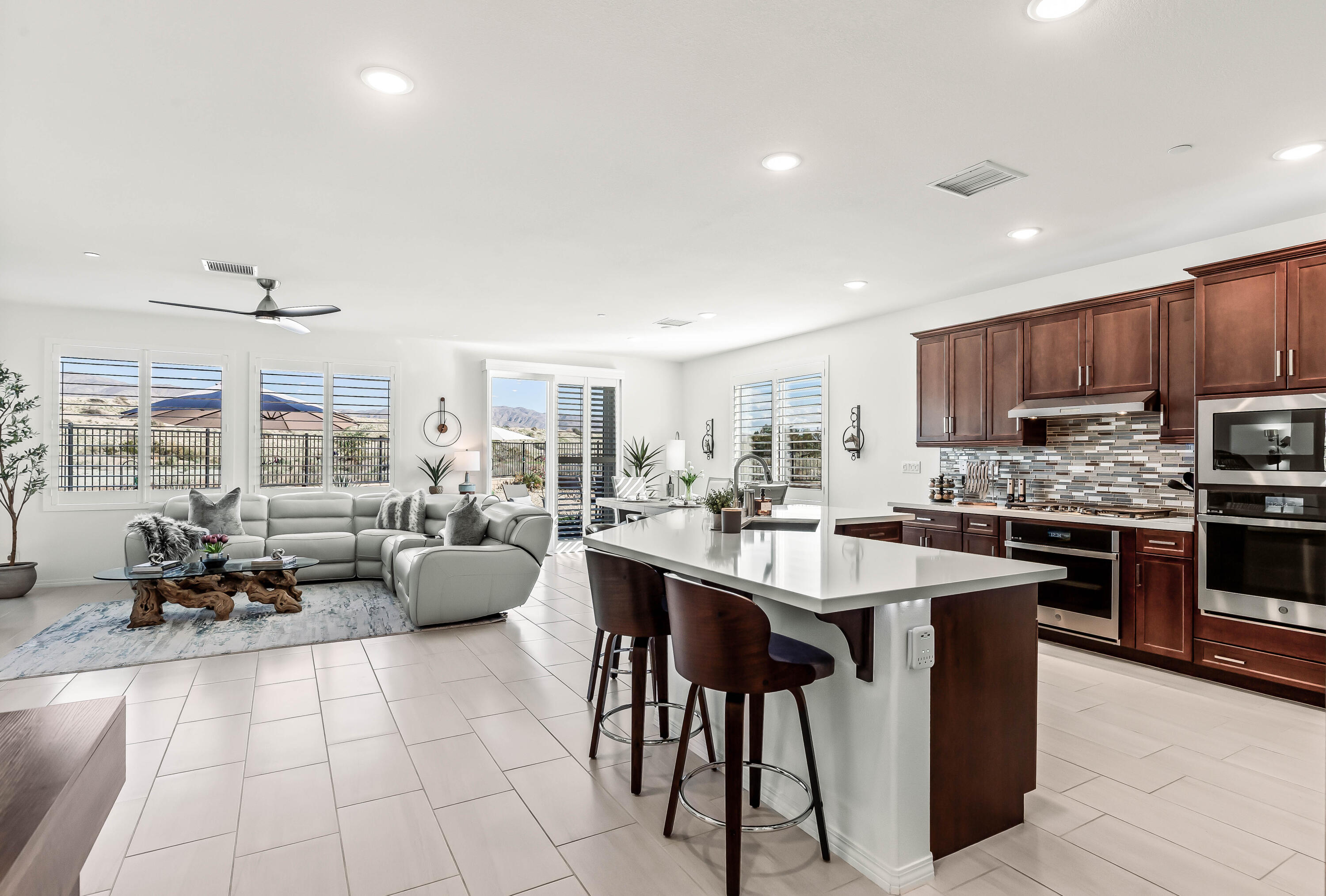 42940 Ascona Lane Indio, CA 92203 - Photo 6 of 36 a large white kitchen with a large window and stainless steel appliances