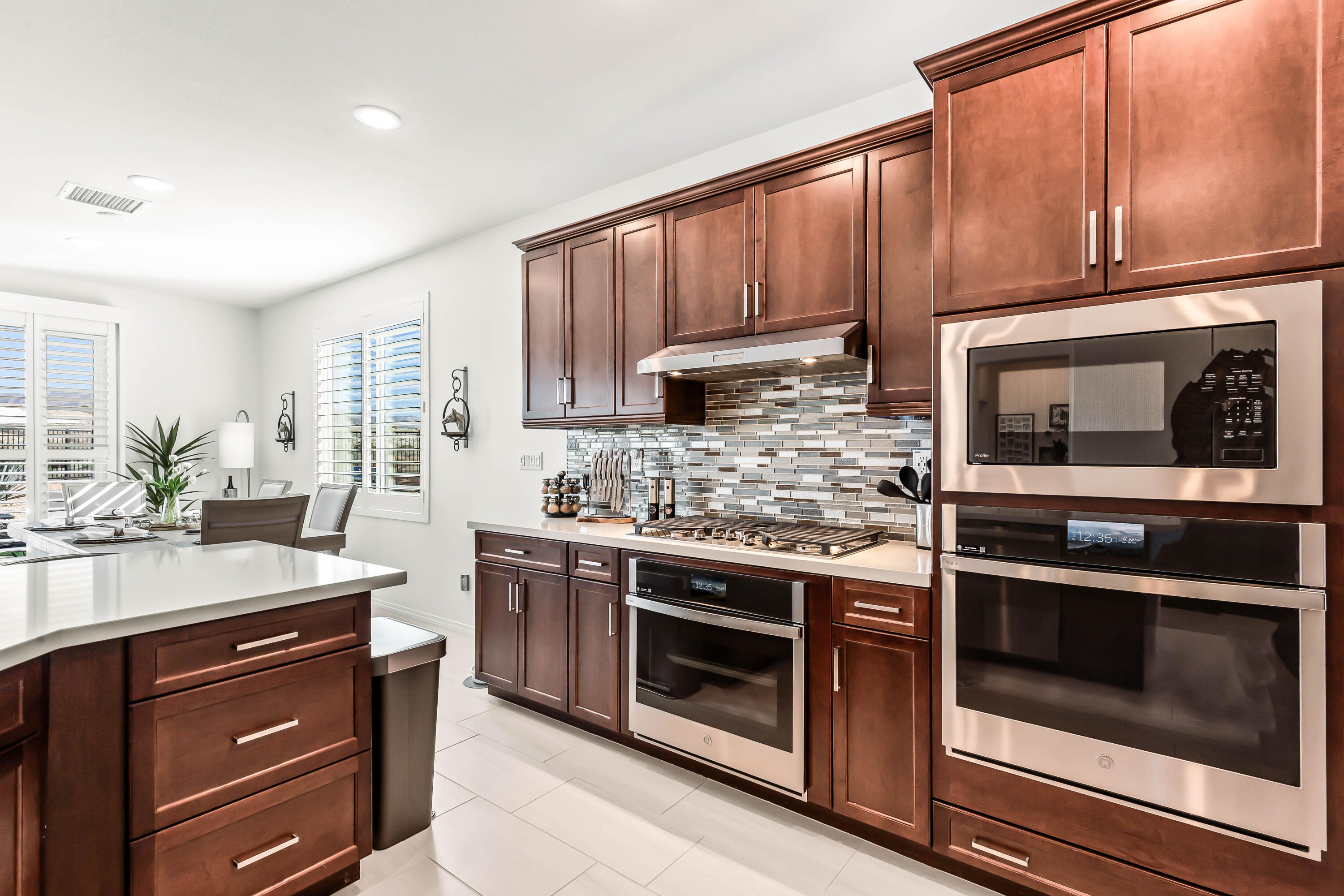 42940 Ascona Lane Indio, CA 92203 - Photo 8 of 36 a kitchen with stainless steel appliances a stove microwave and cabinets