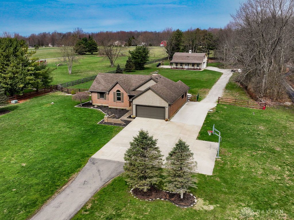 This expansive property offers a charming residence and a versatile outbuilding amidst lush green landscapes.