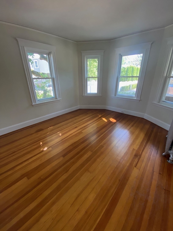 14 Welton Road Boston, MA 02132 - Photo 12 of 31 a view of empty room with window and wooden floor