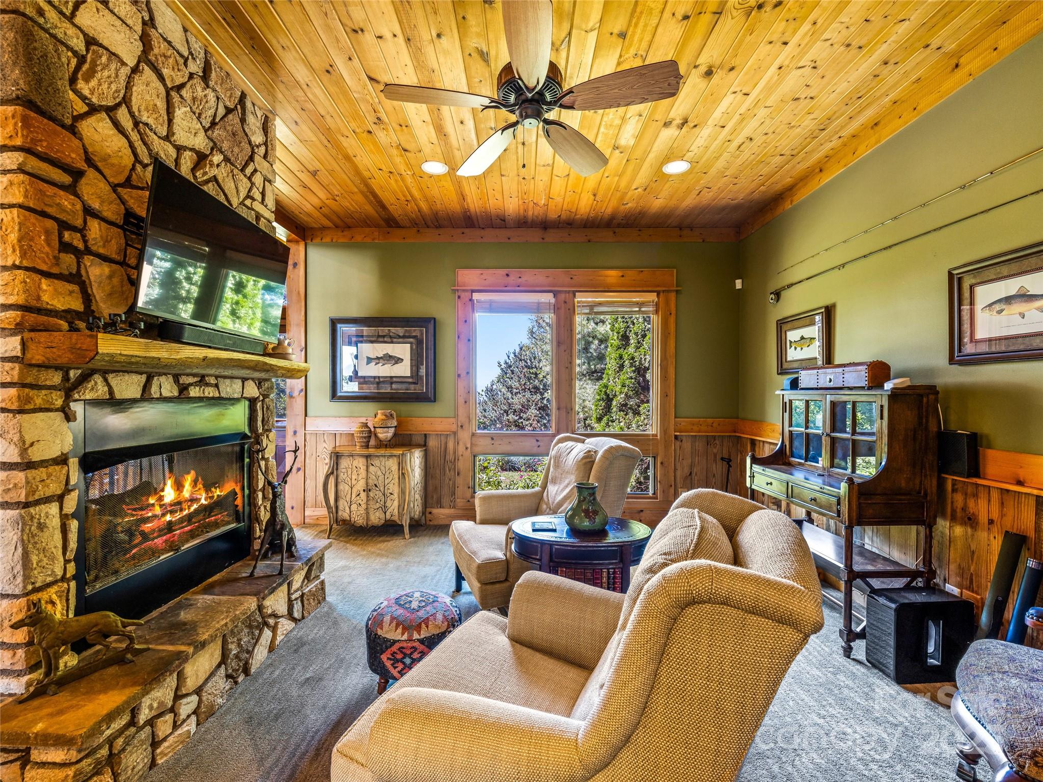 12 Trailridge Road Asheville, NC 28804 - Photo 11 of 45 a living room with furniture a fireplace and a flat screen tv