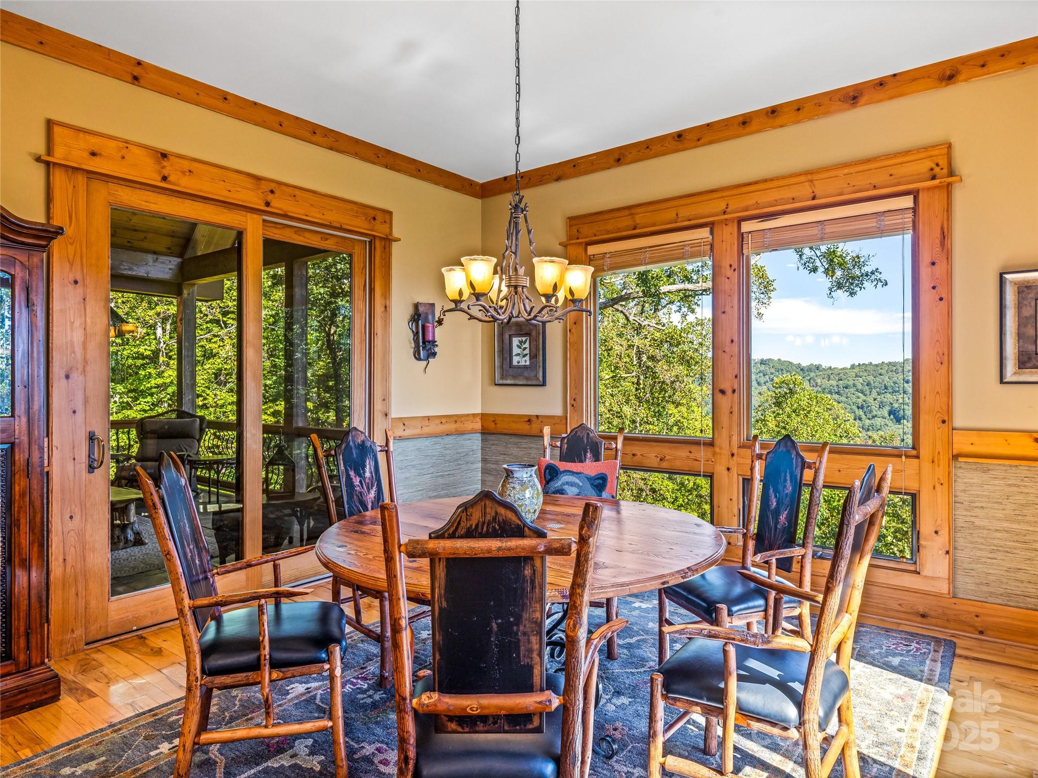12 Trailridge Road Asheville, NC 28804 - Photo 15 of 45 a view of a dining room with furniture large windows and wooden floor