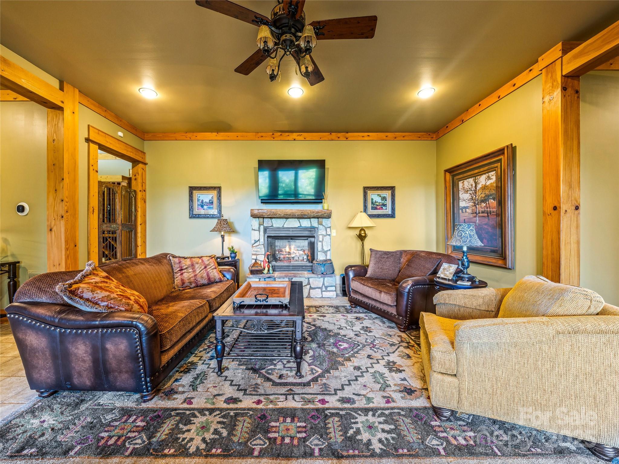 12 Trailridge Road Asheville, NC 28804 - Photo 23 of 45 a living room with furniture a flat screen tv and a fireplace