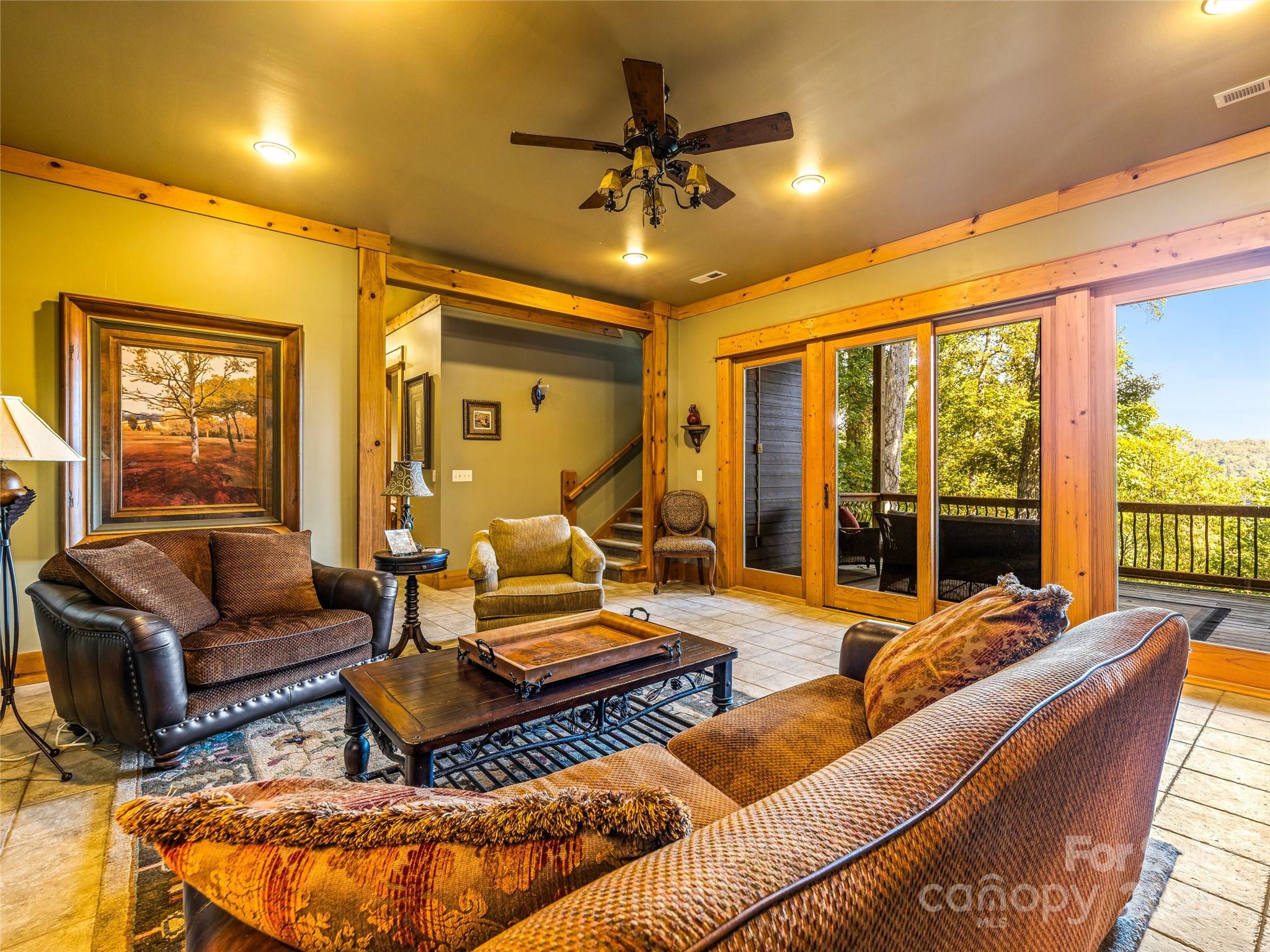 12 Trailridge Road Asheville, NC 28804 - Photo 24 of 45 a living room with furniture ceiling fan and a large window