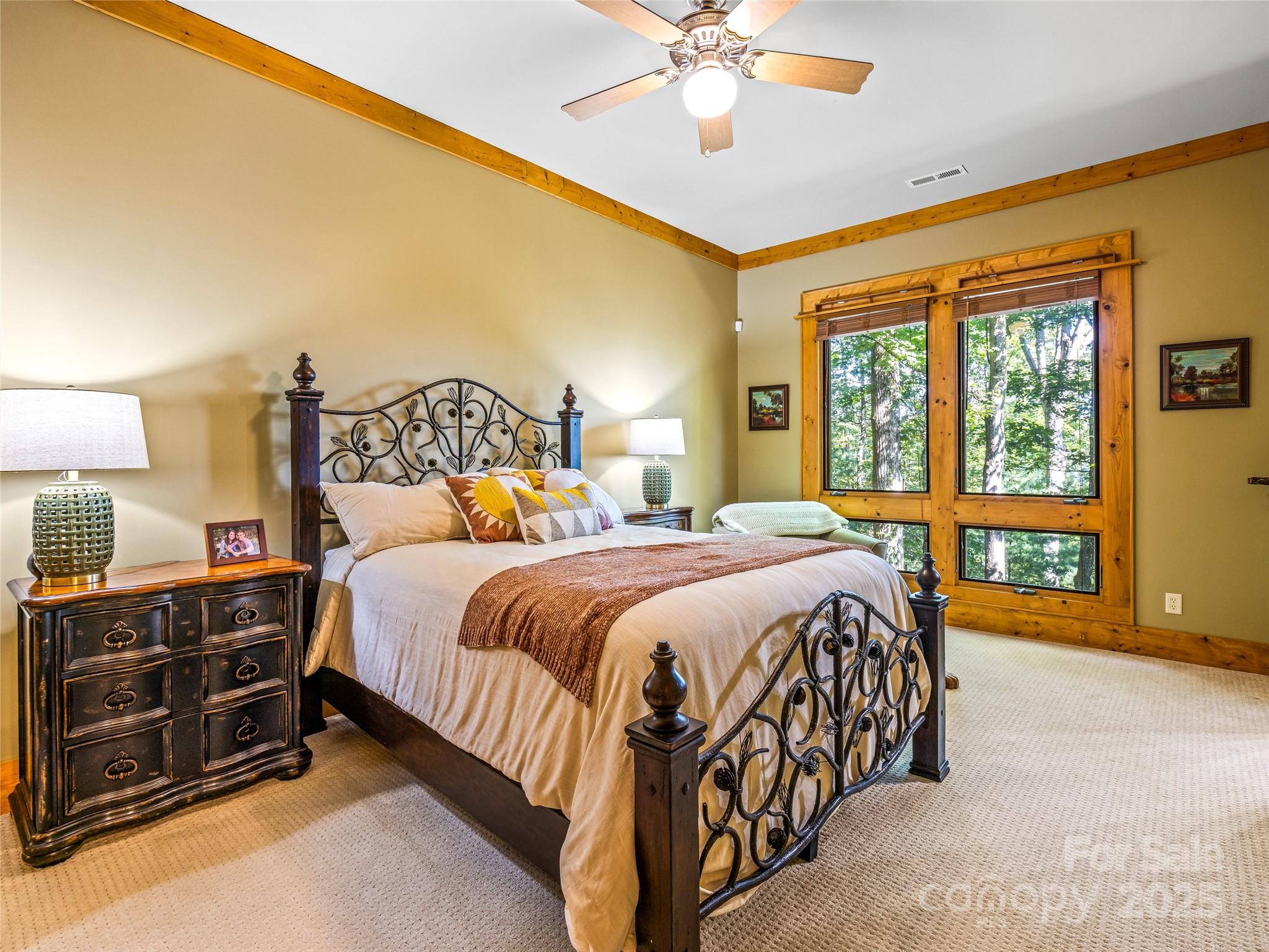 12 Trailridge Road Asheville, NC 28804 - Photo 28 of 45 a bedroom with a bed and a chandelier