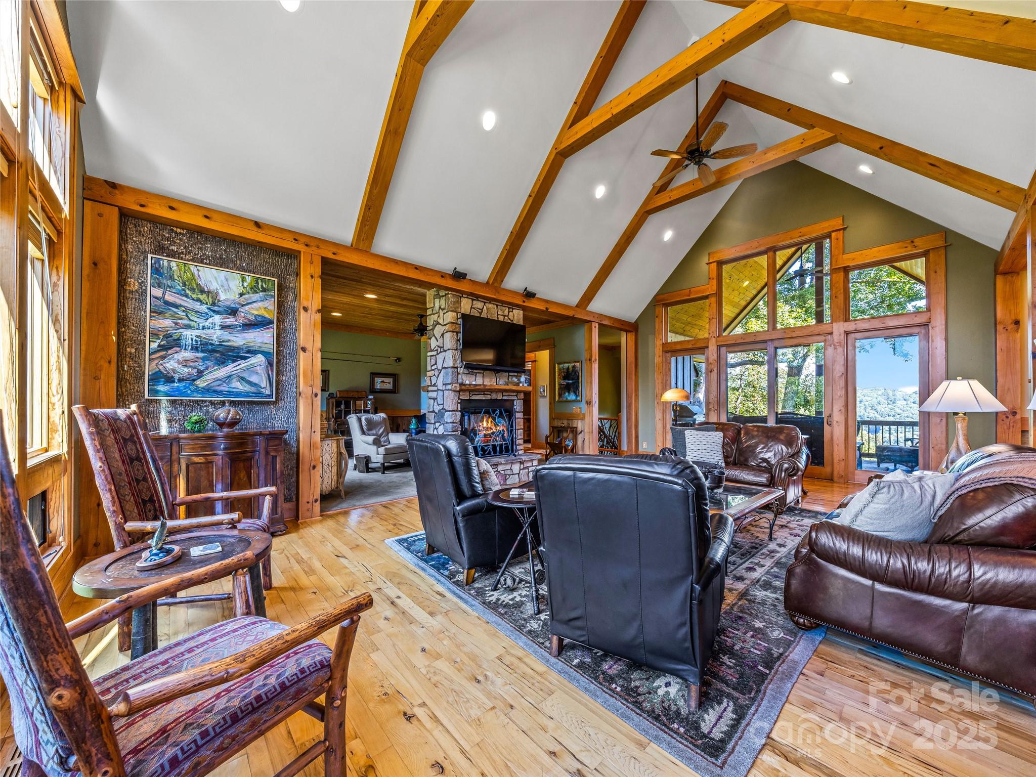12 Trailridge Road Asheville, NC 28804 - Photo 5 of 45 a living room with furniture a flat screen tv and floor to ceiling windows