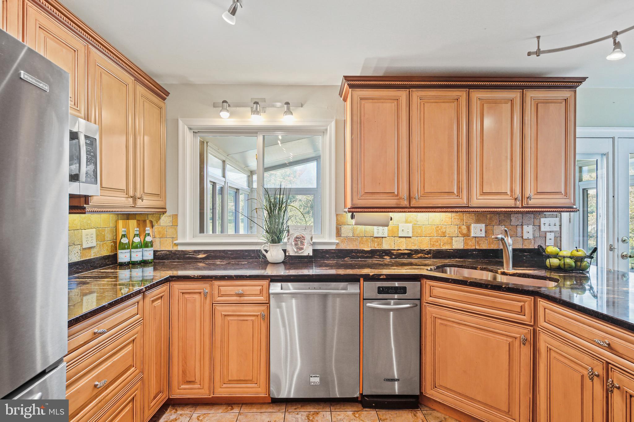 12148 Mt Albert Road Ellicott City, MD 21042 - Photo 12 of 70 a kitchen with stainless steel appliances granite countertop a sink and a stove