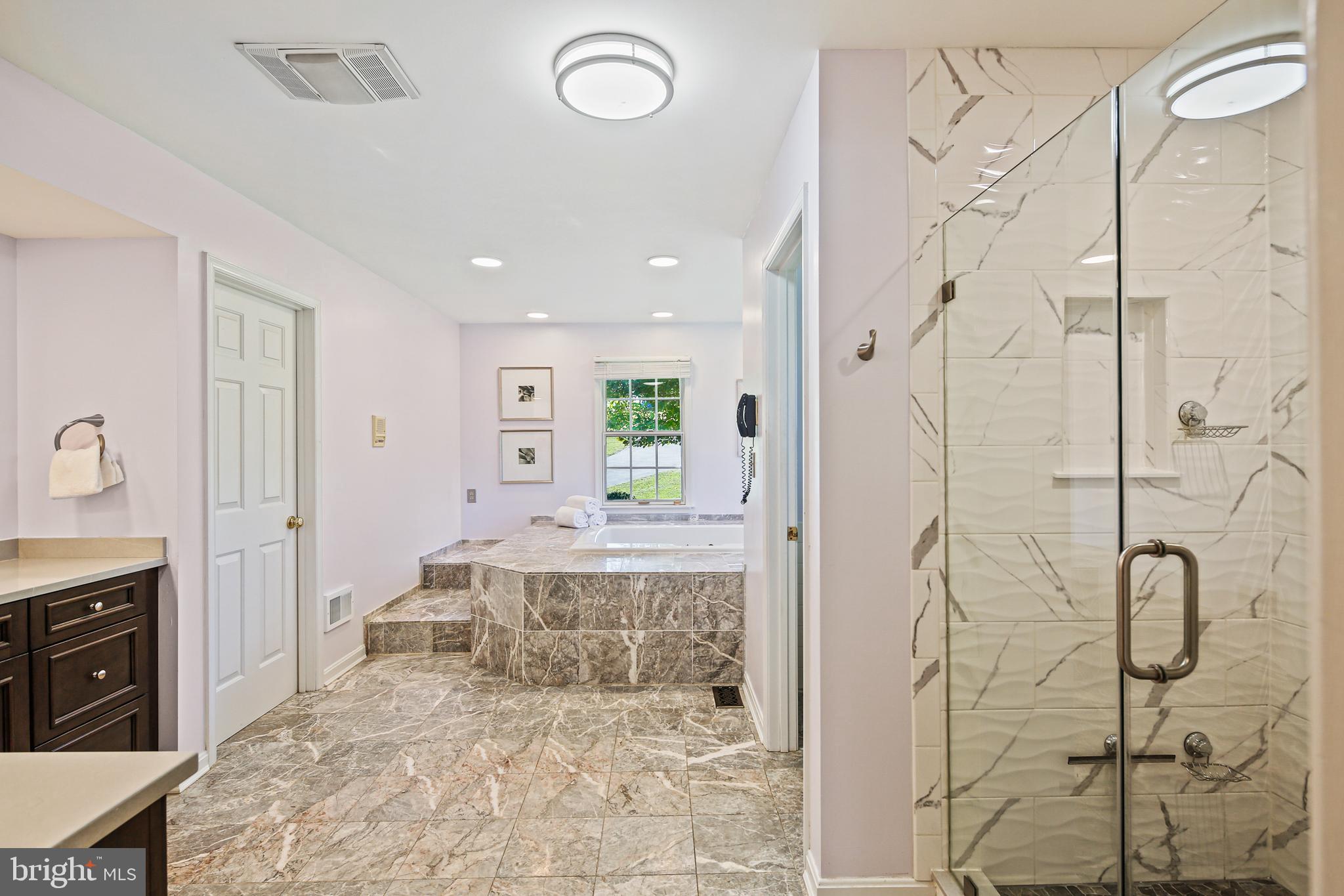 12148 Mt Albert Road Ellicott City, MD 21042 - Photo 27 of 70 a large bathroom with a granite countertop tub shower and mirror