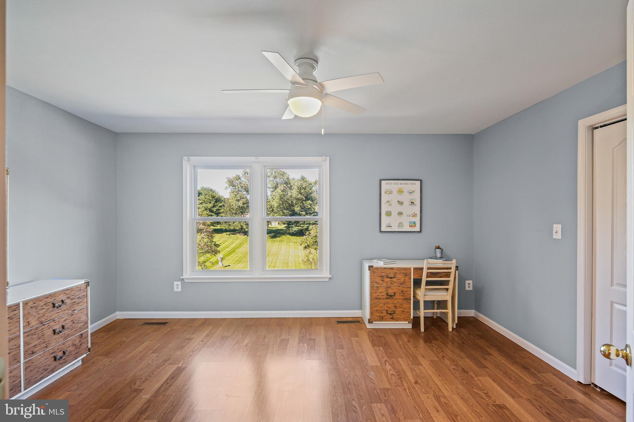 12148 Mt Albert Road Ellicott City, MD 21042 - Photo 35 of 70 a view of an empty room with window and wooden floor