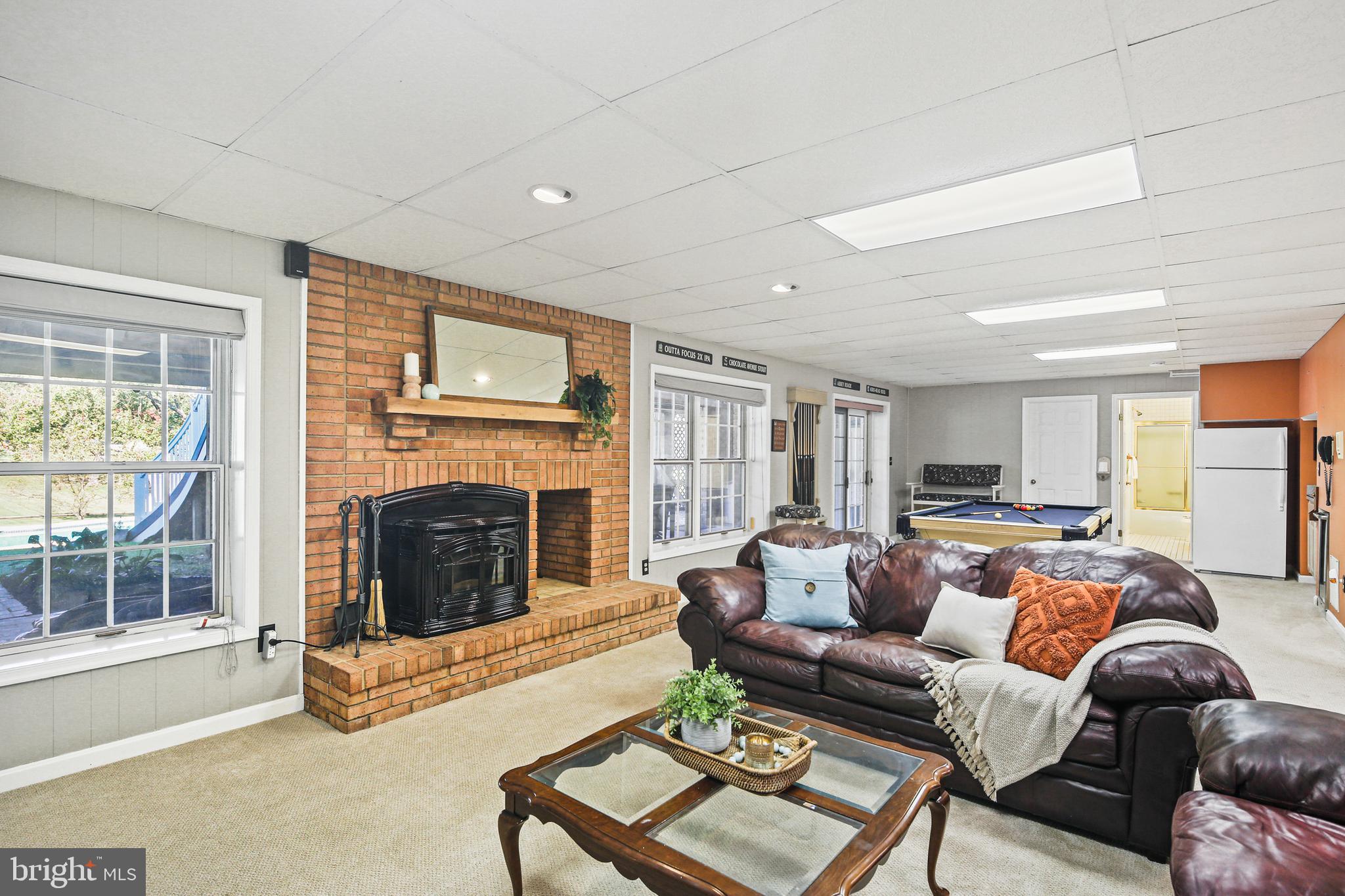 12148 Mt Albert Road Ellicott City, MD 21042 - Photo 38 of 70 a living room with furniture large window and a fireplace