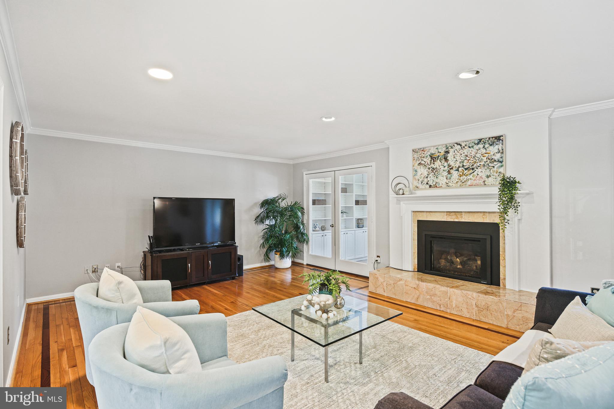 12148 Mt Albert Road Ellicott City, MD 21042 - Photo 4 of 70 a living room with furniture a flat screen tv and a fireplace
