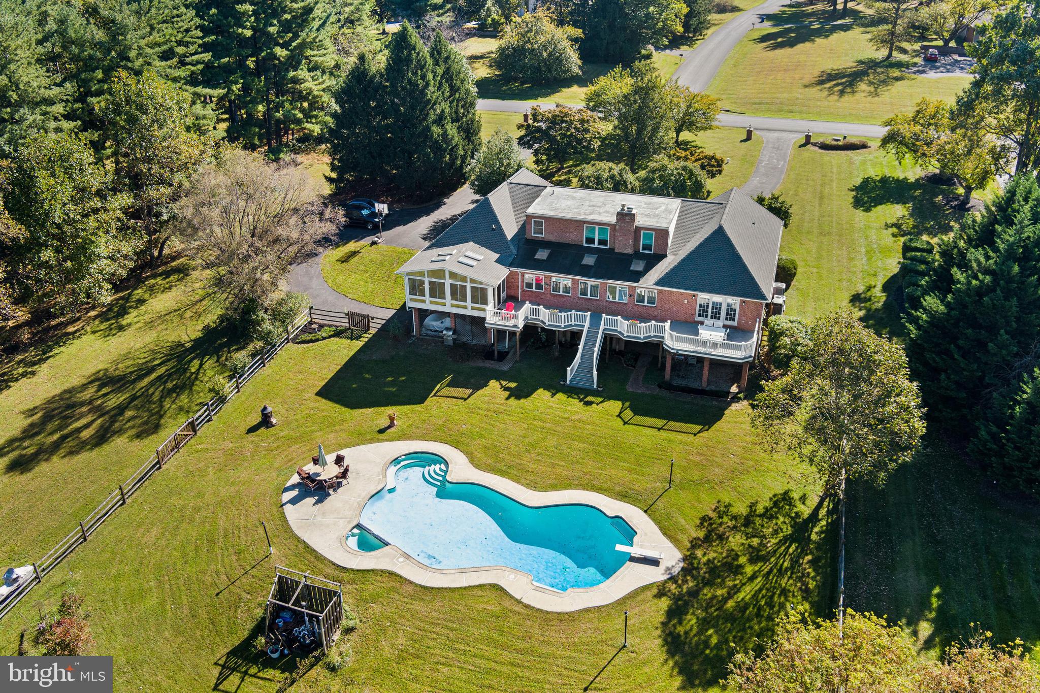 12148 Mt Albert Road Ellicott City, MD 21042 - Photo 62 of 70 an aerial view of a house with swimming pool and large trees
