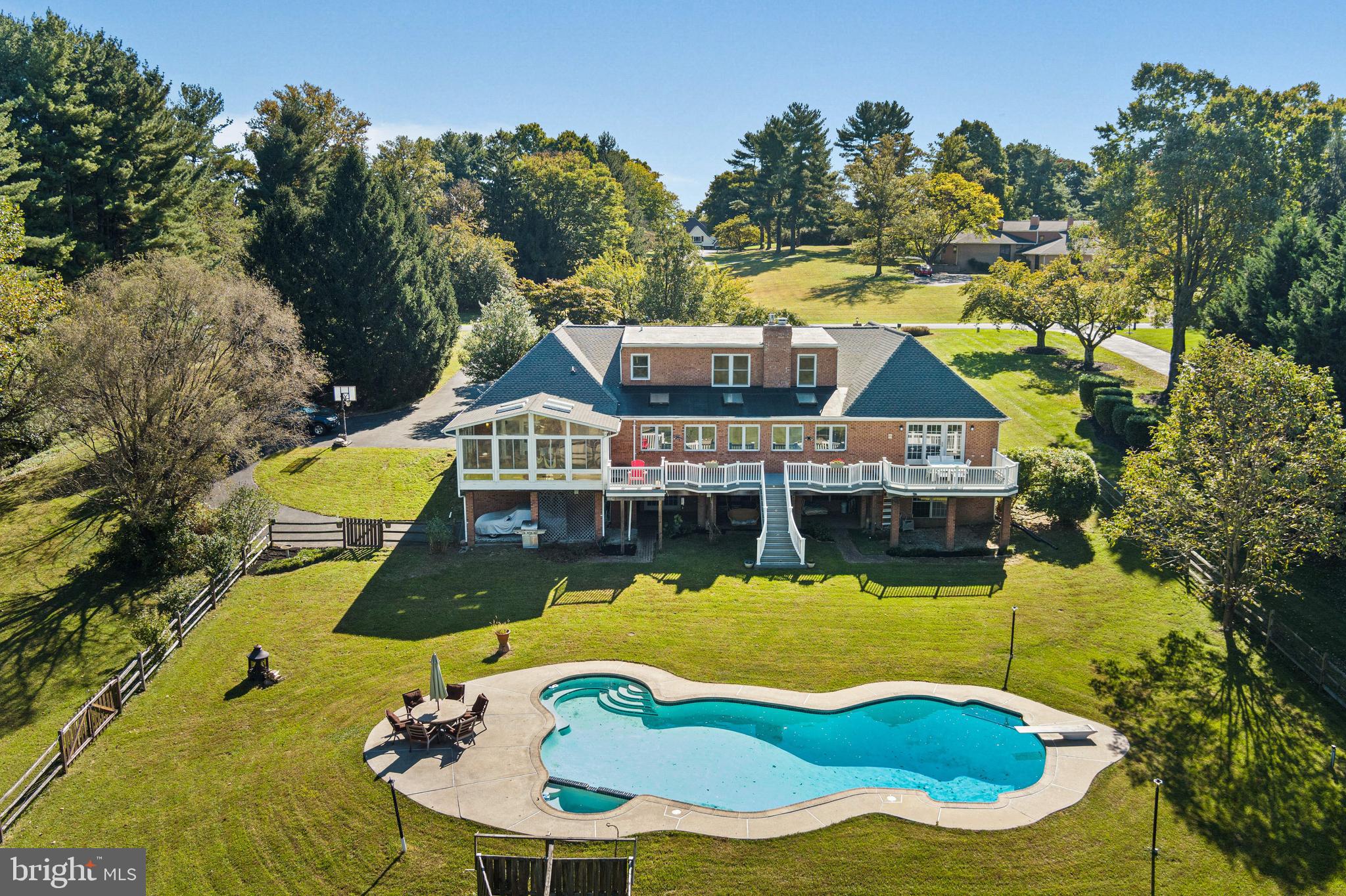 12148 Mt Albert Road Ellicott City, MD 21042 - Photo 63 of 70 an aerial view of a house with swimming pool and large trees