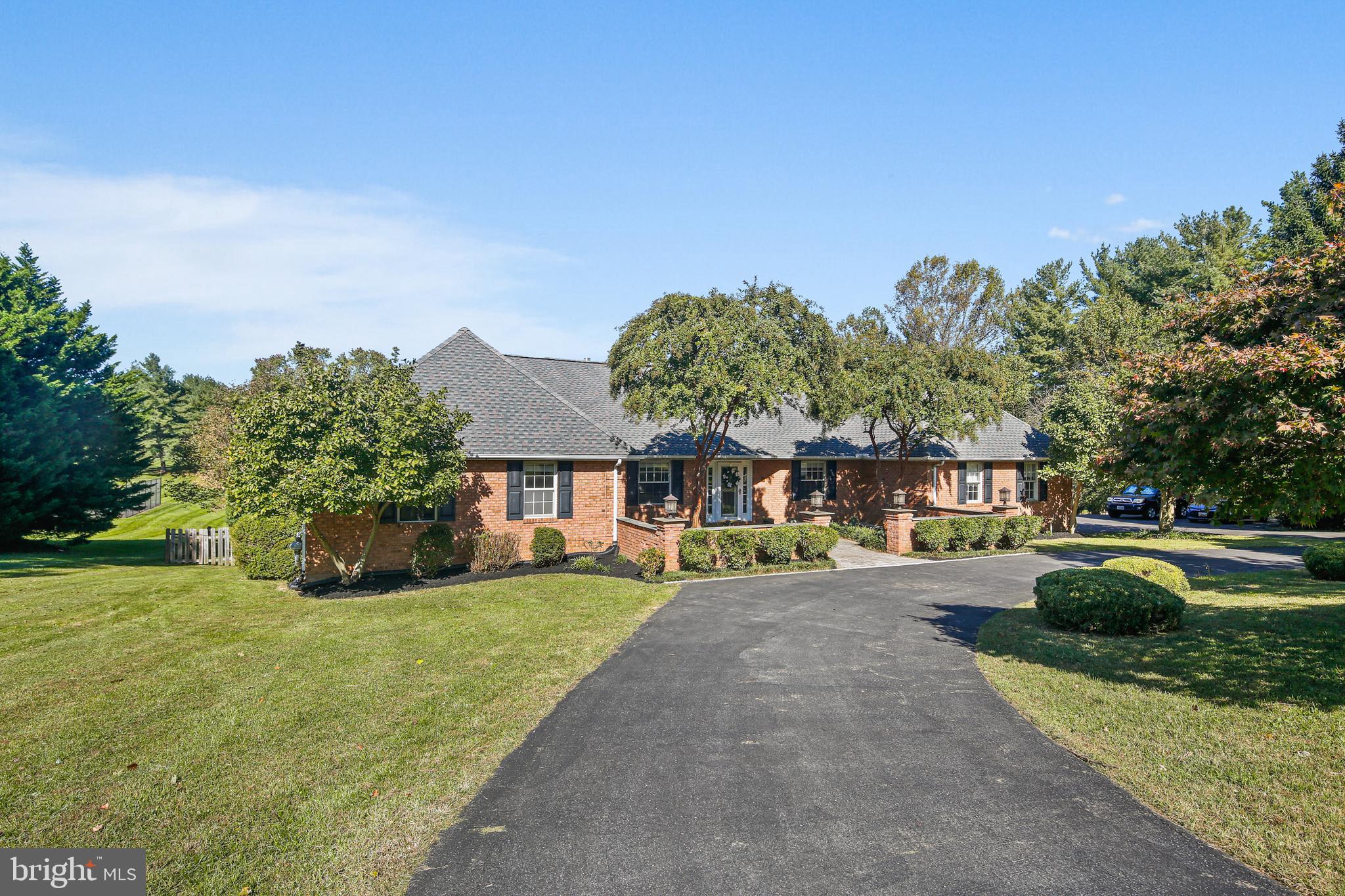 12148 Mt Albert Road Ellicott City, MD 21042 - Photo 69 of 70 a front view of a house with a yard and garage