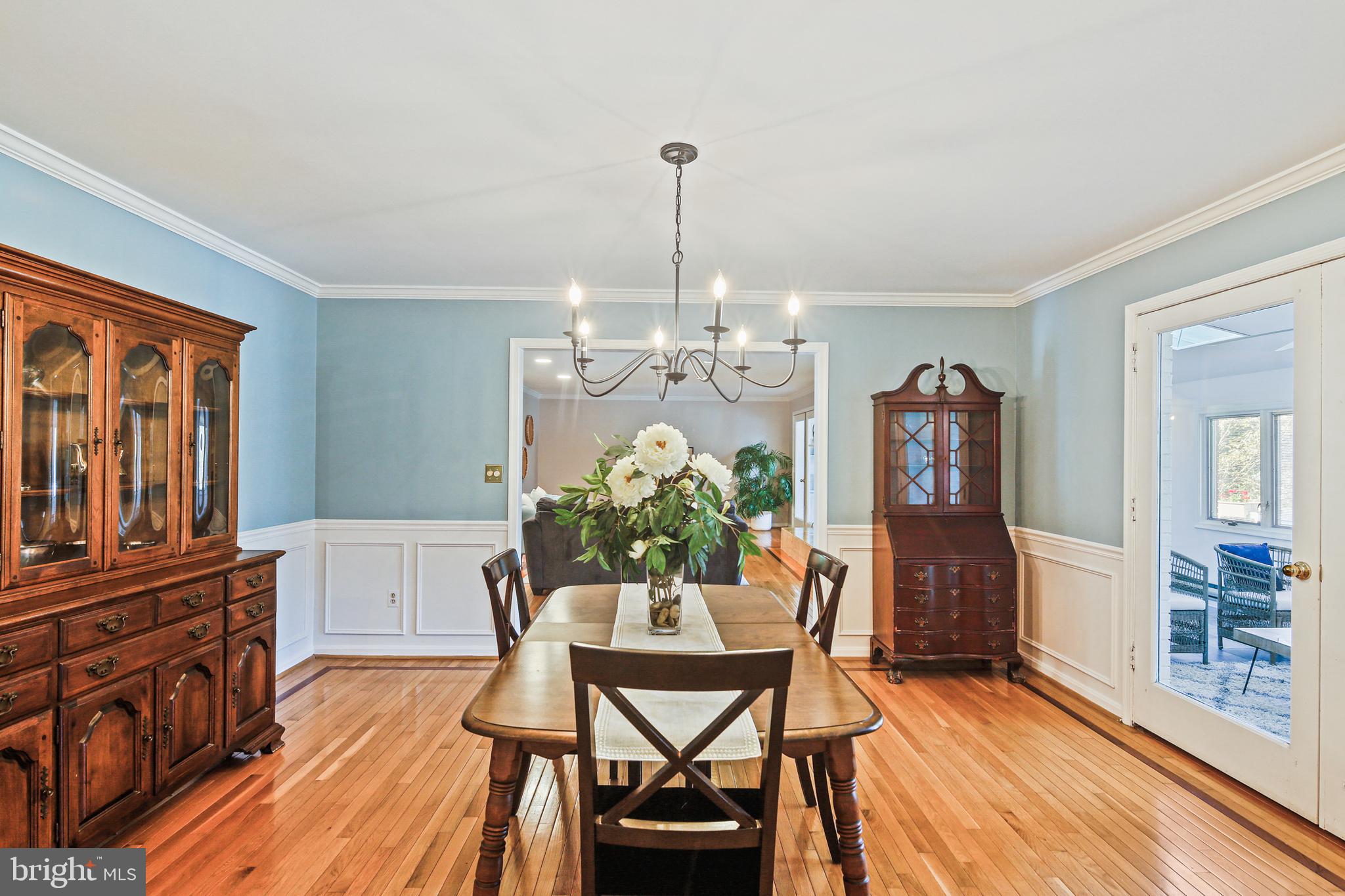 12148 Mt Albert Road Ellicott City, MD 21042 - Photo 9 of 70 a view of a dining room with furniture a chandelier and wooden floor