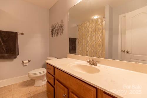 207 Streamside Place Mooresville, NC 28115 - Photo 29 of 42 a bathroom with a granite countertop sink a toilet and a large mirror