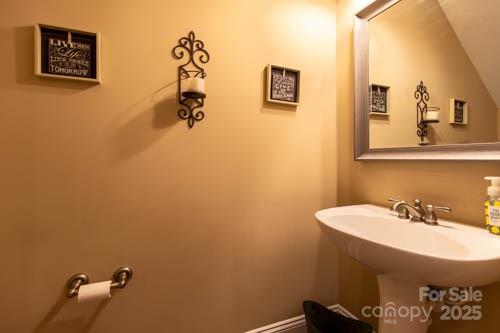 207 Streamside Place Mooresville, NC 28115 - Photo 33 of 42 a bathroom with a sink and a mirror